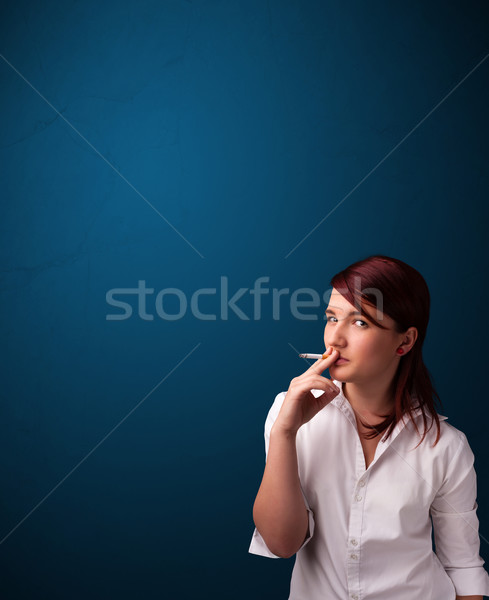 Beautiful woman smoking cigarette vith copy space Stock photo © ra2studio