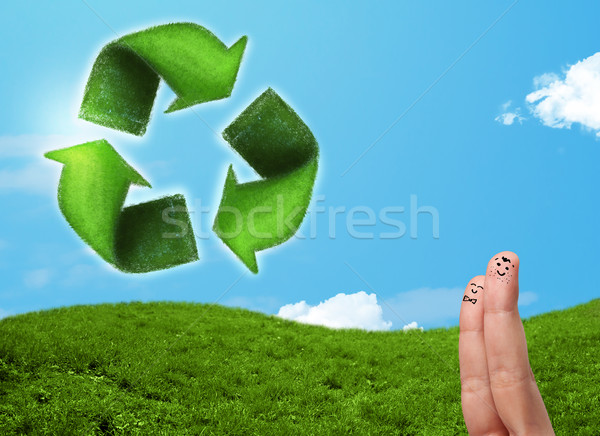 Happy smiley fingers looking at green leaf recycle sign Stock photo © ra2studio