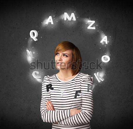 Stock photo: Young woman thinking with letter circulation around her head