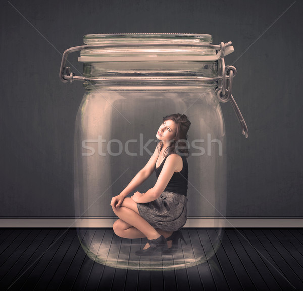 Businesswoman trapped into a glass jar concept Stock photo © ra2studio