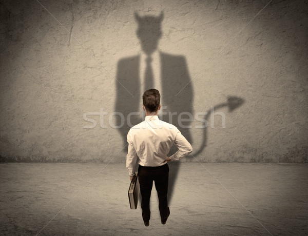Salesman facing his own devil shadow Stock photo © ra2studio
