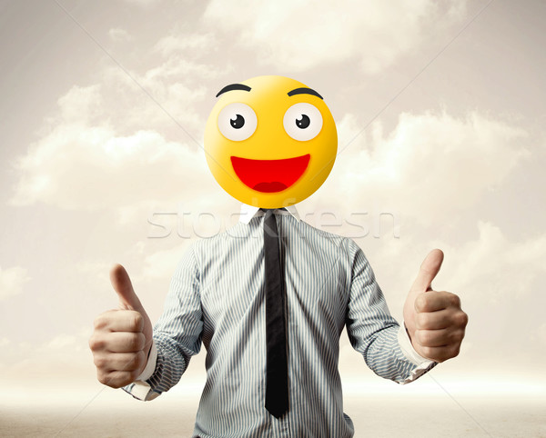 Stock photo: businessman wears yellow smiley face