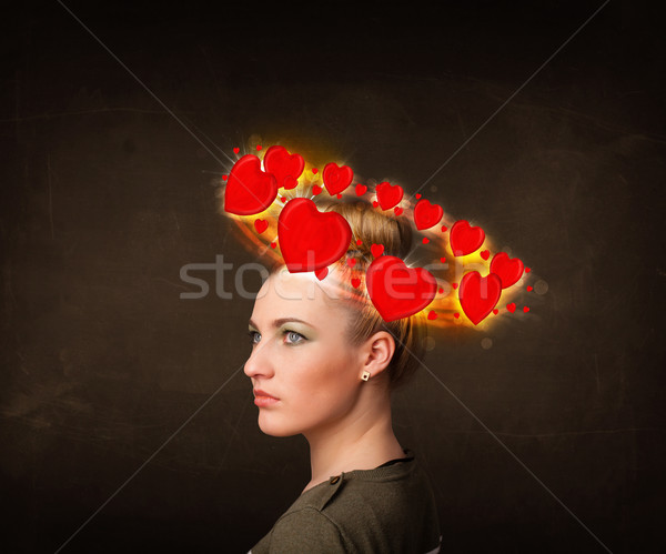 teenager girl with heart illustrations circleing around her head Stock photo © ra2studio