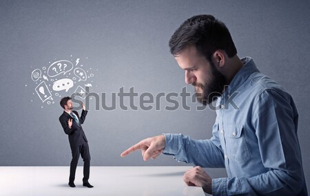 Young businessman fighting with miniature businessman Stock photo © ra2studio