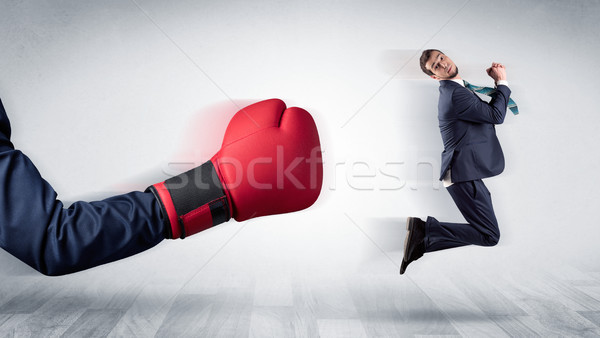 Red boxing glove knocks out little businessman Stock photo © ra2studio