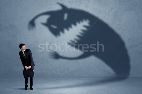Om de afaceri propriu umbră monstru Imagine de stoc © ra2studio