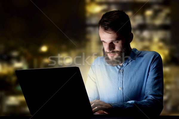 Businessman in the office at night Stock photo © ra2studio