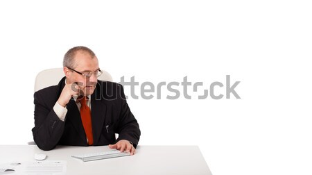 businessman sitting at desk and holding a mobilephone with copys pace, isolated on white Stock photo © ra2studio