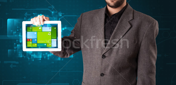 Young businessman holding a tablet with modern software operational system Stock photo © ra2studio