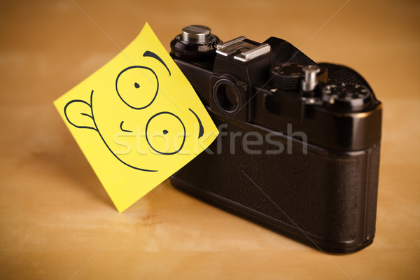 Post-it note with smiley face sticked on a photo camera Stock photo © ra2studio