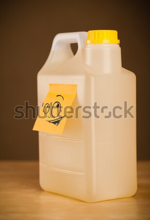 Post-it note with smiley face sticked on gallon Stock photo © ra2studio