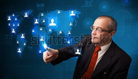 Businessman choosing from social network map Stock photo © ra2studio