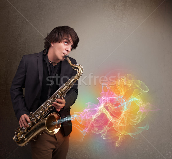 Attractive musician playing on saxophone with colorful abstract  Stock photo © ra2studio