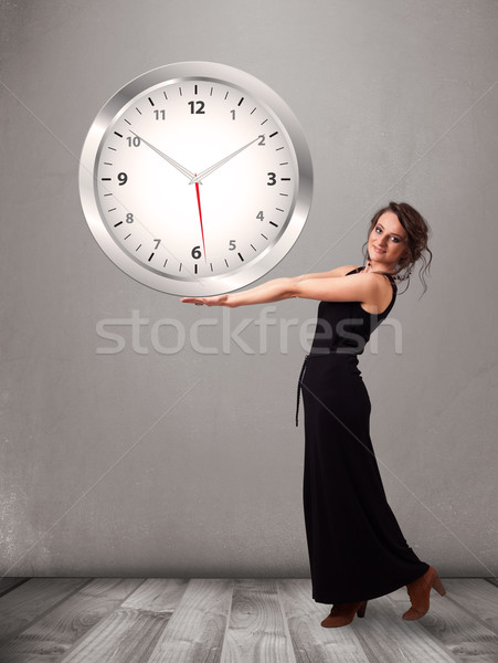 Attractive lady holding a huge clock Stock photo © ra2studio