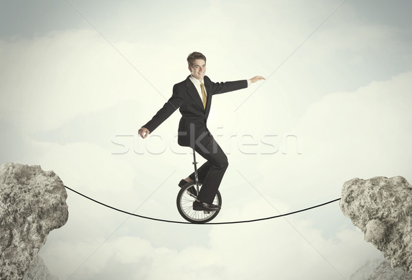 Bátor üzletember lovaglás bicikli sziklák üzlet Stock fotó © ra2studio