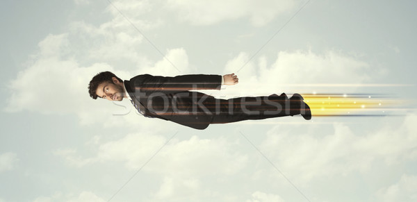 Foto stock: Feliz · homem · de · negócios · voador · rápido · céu · nuvens