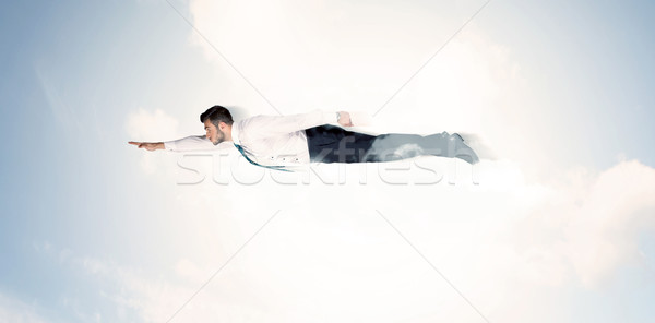 Business man flying like a superhero in clouds on the sky Stock photo © ra2studio