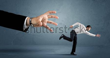 Homme d'affaires courir loin énorme main homme [[stock_photo]] © ra2studio