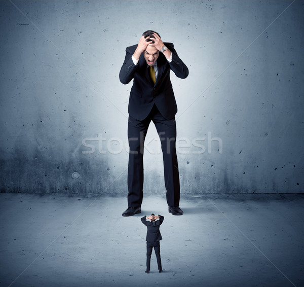 Angry huge business man lokking at small guy Stock photo © ra2studio