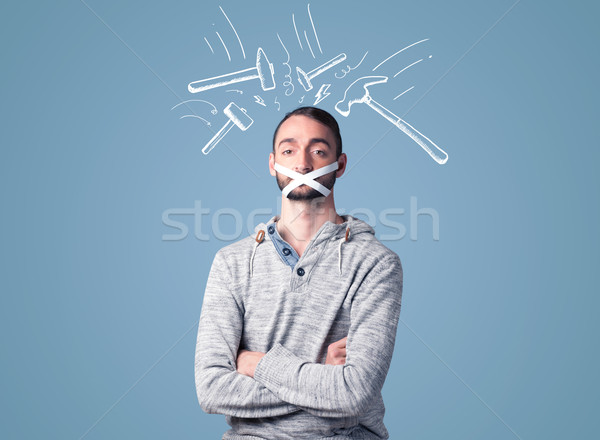 Young man with glued mouth and beating hammer marks Stock photo © ra2studio