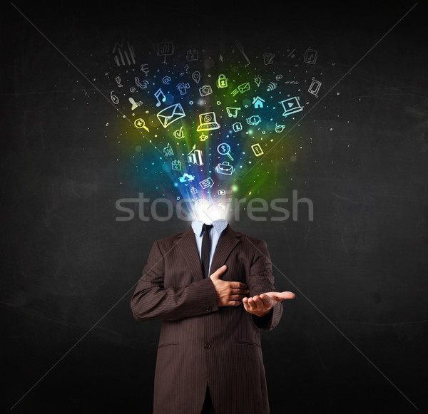 Business man with glowing media icons exploding head  Stock photo © ra2studio