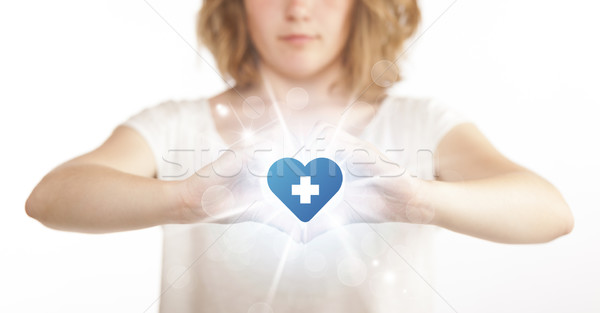 Stock photo: Hands creating a form with heart blue cross