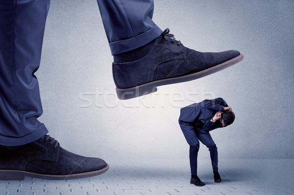 Young businessman getting crushed Stock photo © ra2studio