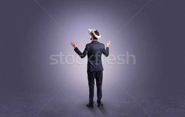 Businessman in an empty room with vr glasses Stock photo © ra2studio