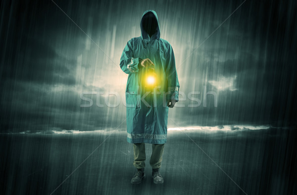 Man walking in storm with lantern Stock photo © ra2studio