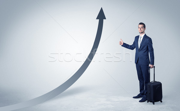 Businessman hitchhiking with progressive arrow Stock photo © ra2studio