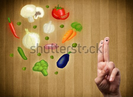 Happy smiley face fingers cheerfully looking at illustration of colorful healthy vegetables Stock photo © ra2studio