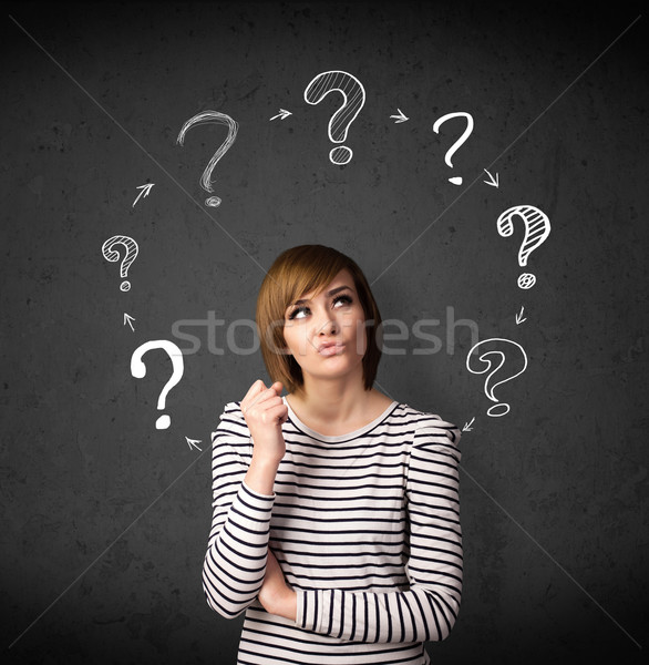 Young woman thinking with question mark circulation around her h Stock photo © ra2studio