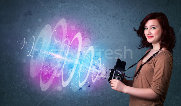 Photographer girl making photos with powerful light beam Stock photo © ra2studio