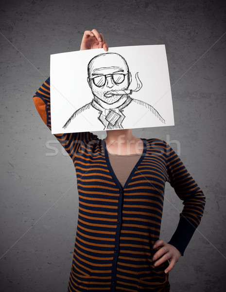 Woman holding a cardboard with a smoking man on it in front of h Stock photo © ra2studio