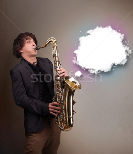 Young man playing on saxophone with copy space in white cloud Stock photo © ra2studio