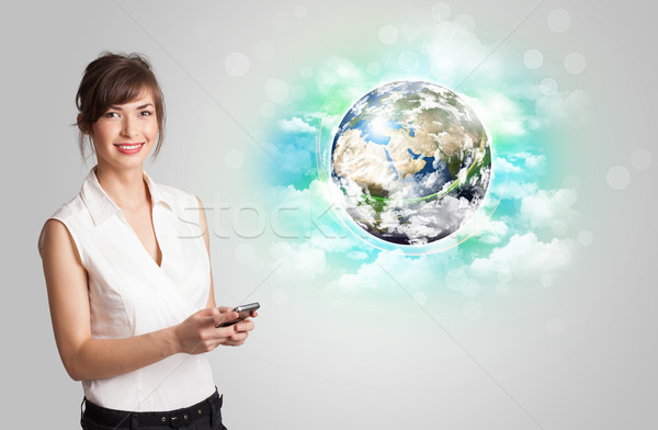 Stock photo: Young woman with earth and cloud concept