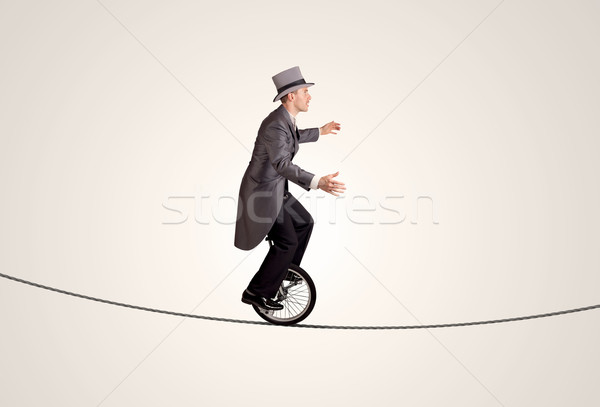 Extreme Geschäftsmann Reiten Einrad Seil Business Stock foto © ra2studio