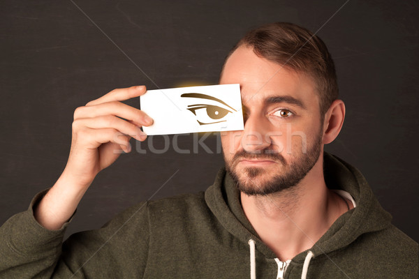 Cool youngster looking with a paper hand drawn eyes Stock photo © ra2studio