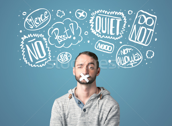 Stock photo: Young man with glued mouth and thought clouds