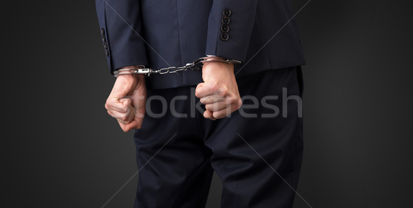 Dark backgrounded close handcuffed man Stock photo © ra2studio