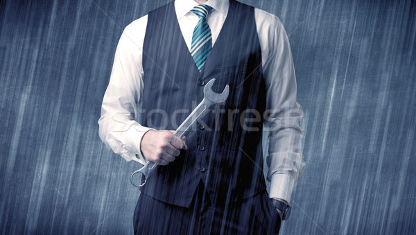 Employer standing with tool on his hand Stock photo © ra2studio
