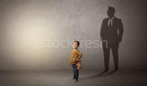 Little boy with businessman shadow Stock photo © ra2studio