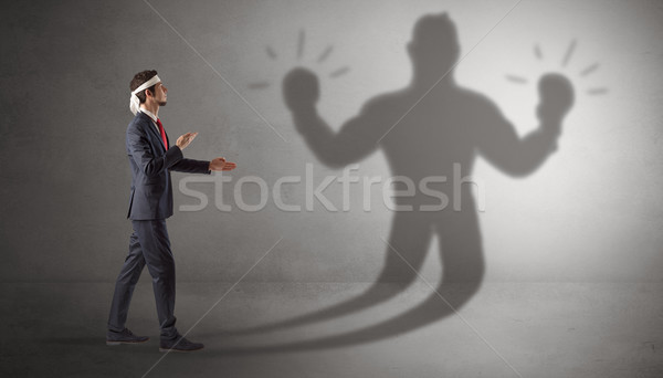 Businessman fighting with his unarmed shadow Stock photo © ra2studio