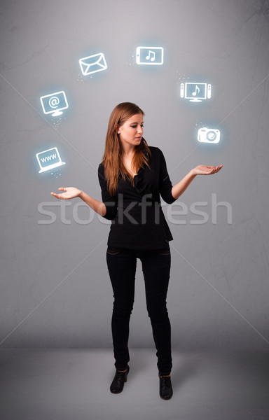 pretty girl juggling with elecrtonic devices icons Stock photo © ra2studio