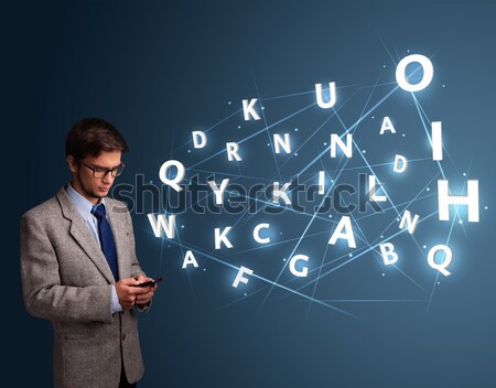 Handsome young man typing on smartphone with high tech 3d letters comming out Stock photo © ra2studio