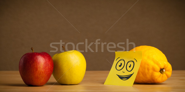 Lemon with post-it note watching at apples Stock photo © ra2studio