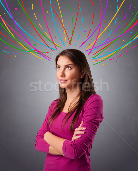 Young girl thinking with colorful abstract lines overhead Stock photo © ra2studio