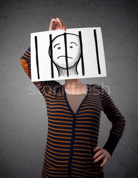 Woman holding a paper with a prisoner behind the bars on it in f Stock photo © ra2studio