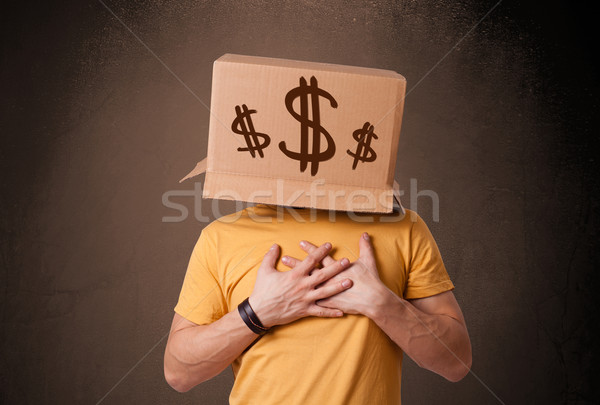 Young man gesturing with a cardboard box on his head with dollar Stock photo © ra2studio