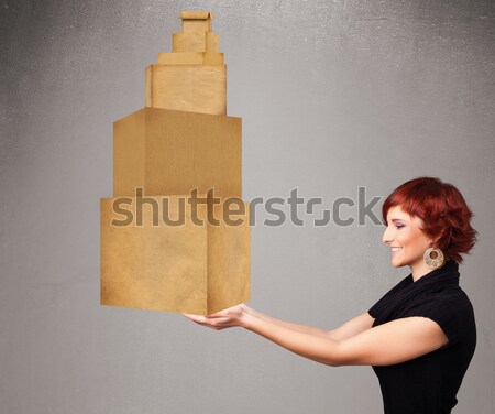 Young lady holding a set of brown cardboard boxes Stock photo © ra2studio